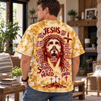 A man wearing a yellow and white tie-dye t-shirt with a large graphic print of Jesus on the back, standing in a living room setting.